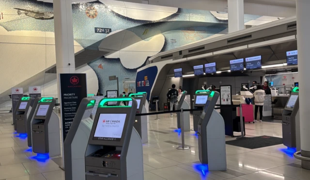 An empty set of self-service check in terminals at LaGuardia Airport.