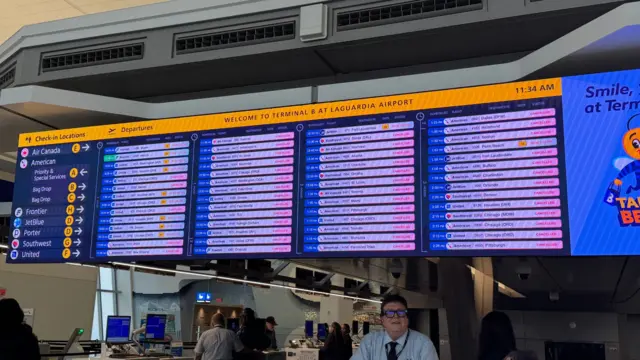 A flights departure board at LaGuardia Airport