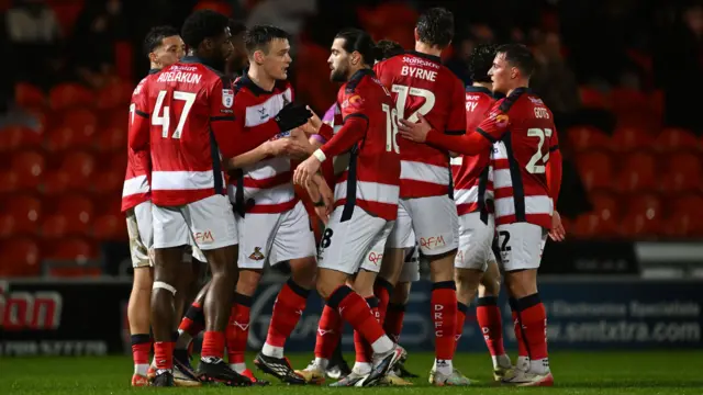 Doncaster Rovers players celebrate going 1-0 up against Port Vale