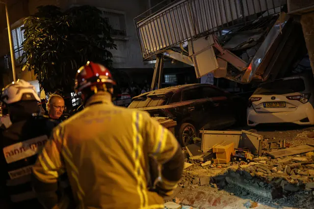 Emergency personnel work at the site where a building was struck by a projectile in Bnei Brak.