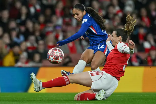 Alyssa Thompson (top) is tackled by Arsenal's Spanish defender #05 Laia Codina during the UEFA Women's Champions League quarter-final 1st leg football match between Arsenal and Chelsea at The Emirates Stadium in London