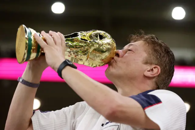 England fan celebrates with a trophy