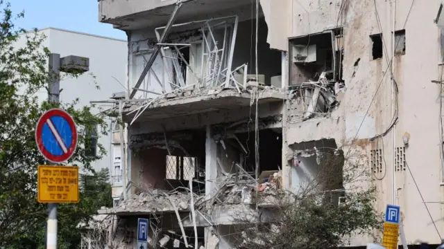 Damage at the site of an Iranian missile strike in a residential area in Tel Aviv,