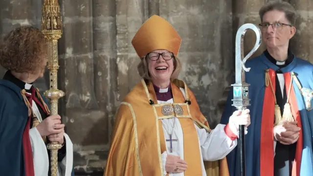 Archbishop of Canterbury Dame Sarah Mullally laughs following the installation ceremony