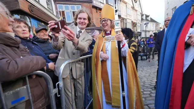 Sarah Mullally smiles with a man taking a selfie