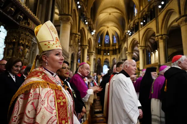 Clergymen and women in the aisles of the cathedral