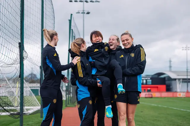 Hinata Miyazawa is lifted by Manchester United team-mates