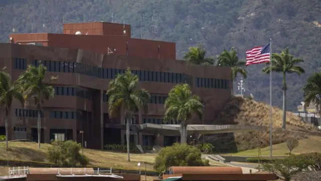 A view shows the United States flag being raised at the diplomatic headquarters in Caracas, Venezuela, 14 March 2026.
