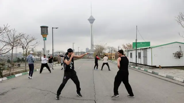 Iranian people exercise at Pardisan Park, amid the U.S.-Israeli conflict with Iran, in Tehran, Iran