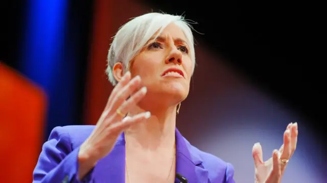 A file photo of Daisy Cooper on stage, speaking to a crowd