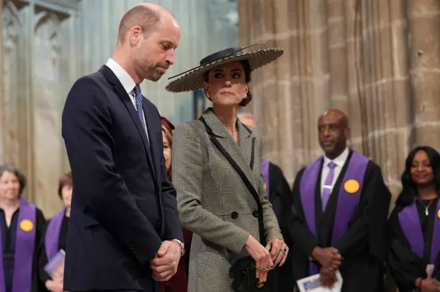 Catherine looks over at William with clergy in background during ceremony