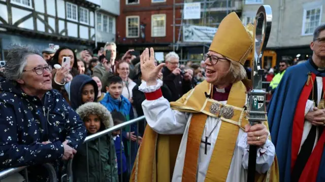 Sarah Mullally waves at a crowd