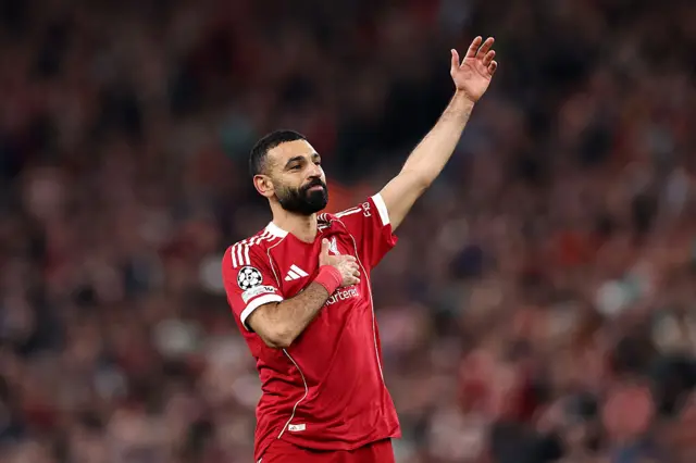 Mohamed Salah taps Liverpool badge