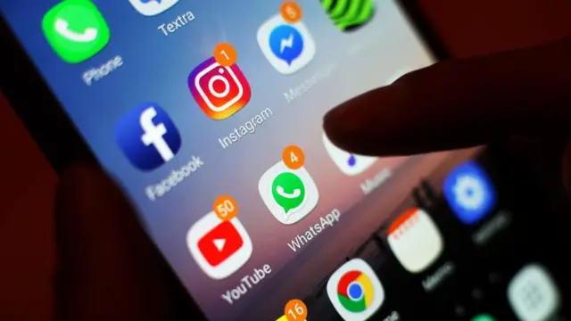 A phone showing social media app icons