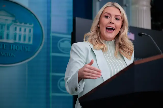 Karoline Leavitt gestures from behind the White House lectern