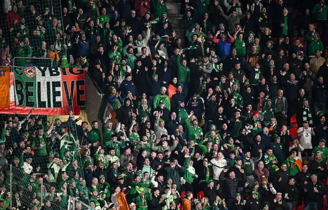 Ireland fans with a 'believe' banner in the away end