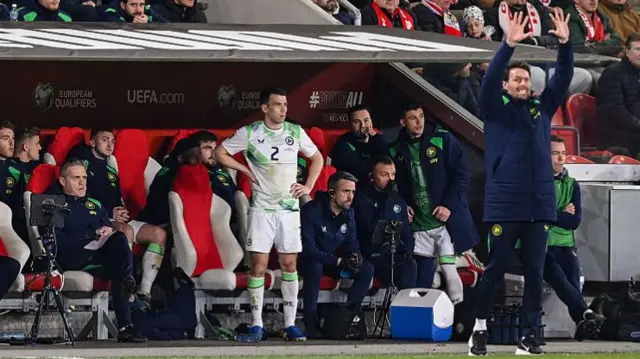 Seamus Coleman stands inside the dugout