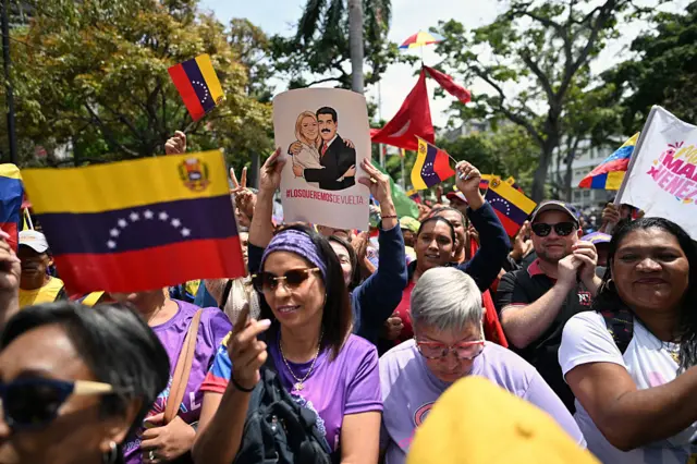 Supporters of Venezuela's ousted president Nicolas Maduro demonstrate with a poster of him and his wife Cilia Flores reading "We want them back" and Venezuelan national flags in Caracas.