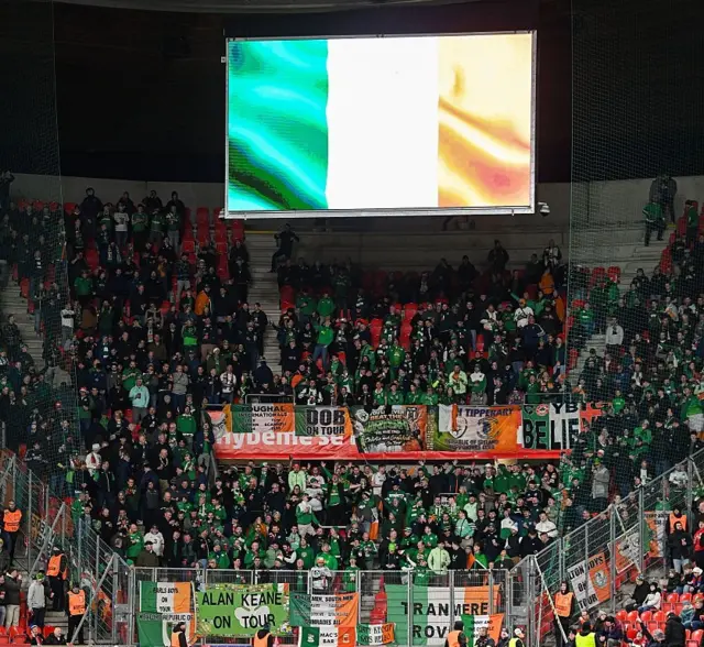 Ireland fans sing along to the national anthem in the away end