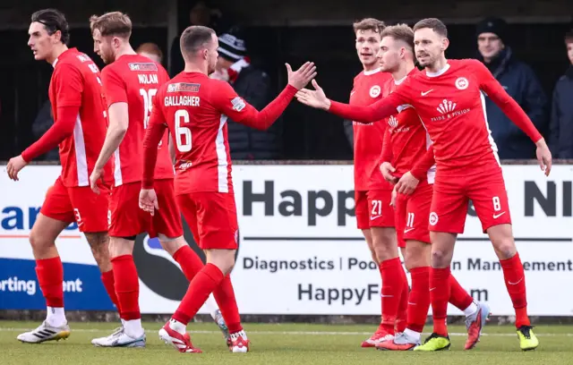 Chris Gallagher celebrates with Larne team-mate Mark Randall