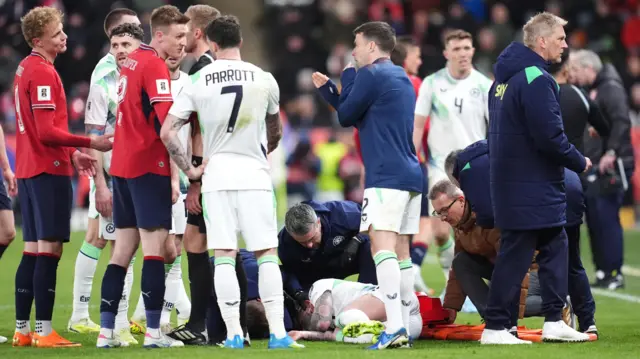 Szmodics receives treatment after a nasty head collision