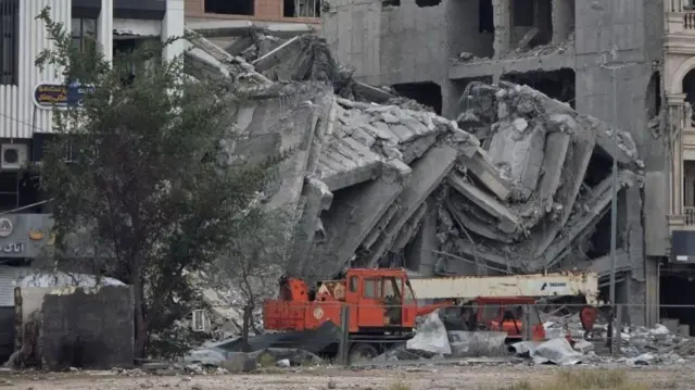 A grab from the footage shows the eight-storey apartment block is now a pile of rubble