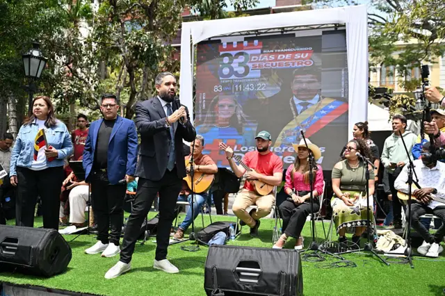 Venezuela's politician Nicolas Maduro Guerra (holding a microphone), son of Venezuela's ousted president Nicolas Maduro, speaks to supporters during a demo in Caracas