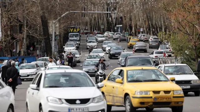Motorists on a street, amid the U.S.-Israeli conflict with Iran, in Tehran, Iran, March 24, 2026.