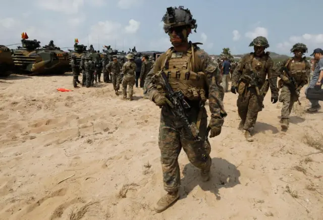 US Marines can be seen on sand