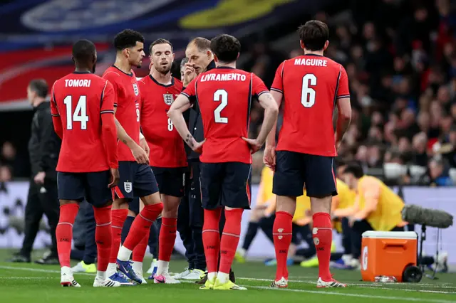 Tuchel chats to his players by the touchline