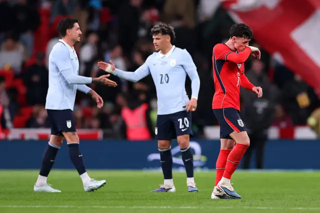 Uruguay players low five as Foden trudges off