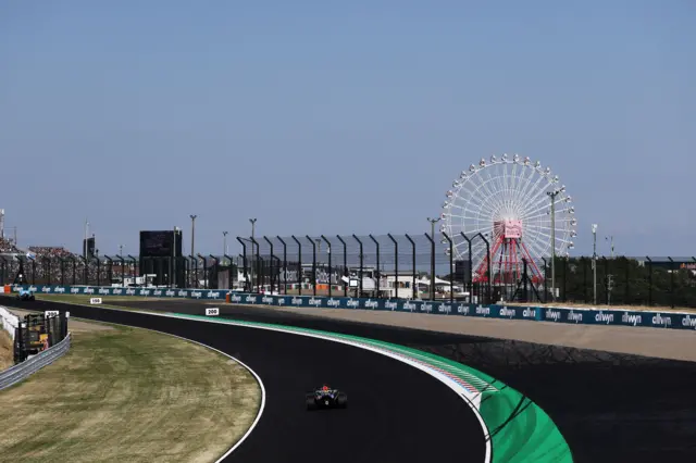 A rear view of Max Verstappen's Red Bull with the Suzuka big wheel in the background