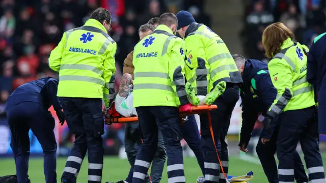 Sammie Szmodics is stretchered off the pitch