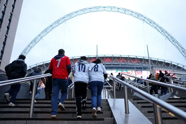 Fans climb the steps on Wembley way