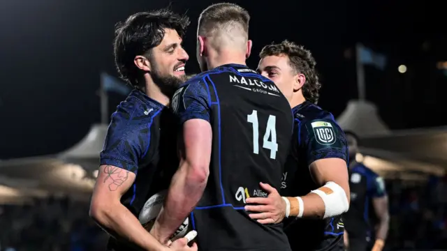 Glasgow's Fergus Watson celebrates scoring a try with Adam Hastings and Josh McKay