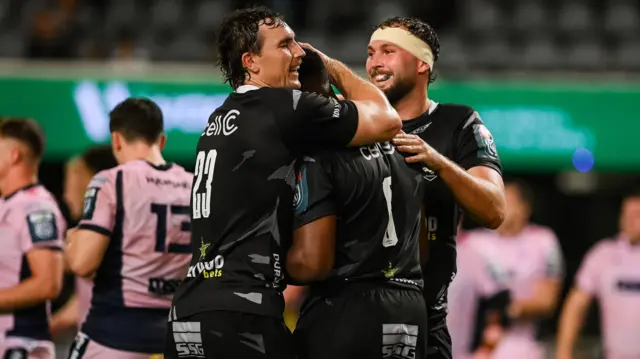 Le Roux Malan and Nick Hatton celebrate with Phepsi Buthelezi of Hollywoodbets Sharks after he scored a try