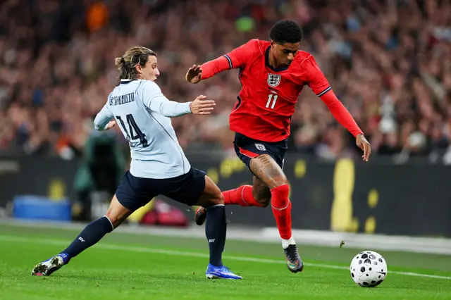 Rashford skips past a challenge on the wing