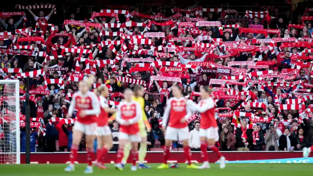 Arsenal fans hold scarves etc aloft before kick off