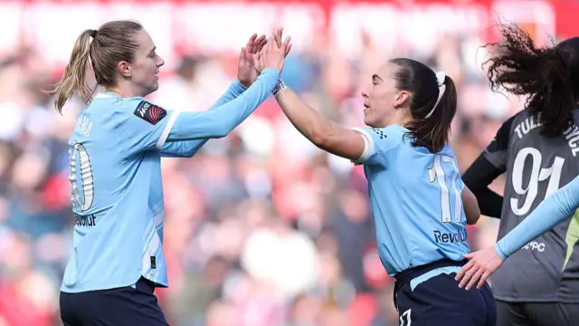 Vivianne Miedema celebrates scoring with teammate Sam Coffey