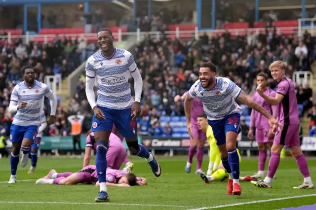 Reading's Kelvin Ehibhatiomhan celebrates after scoring their third goal against Wigan with Derrick Williams