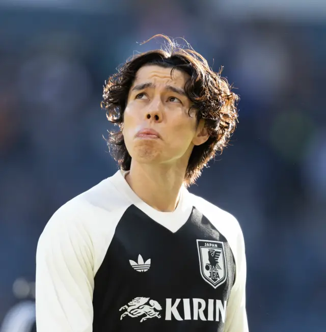 Japan midfielder Ao Tanaka warms up
