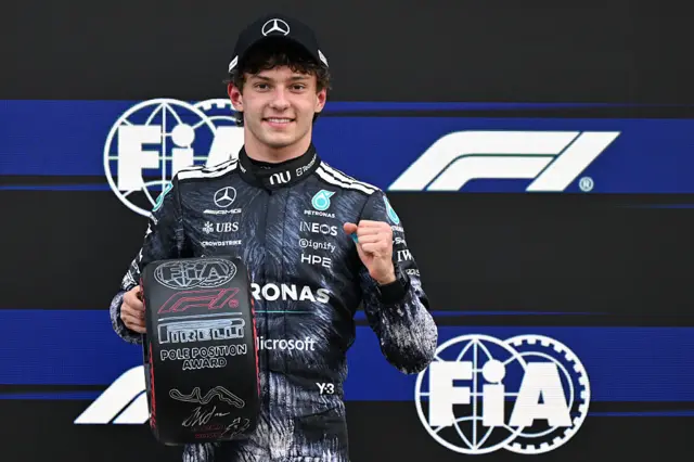 Kimi Antonelli holds the pole position tyre award in Japan
