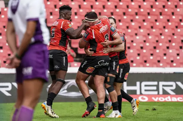 Dragons players celebrate a try