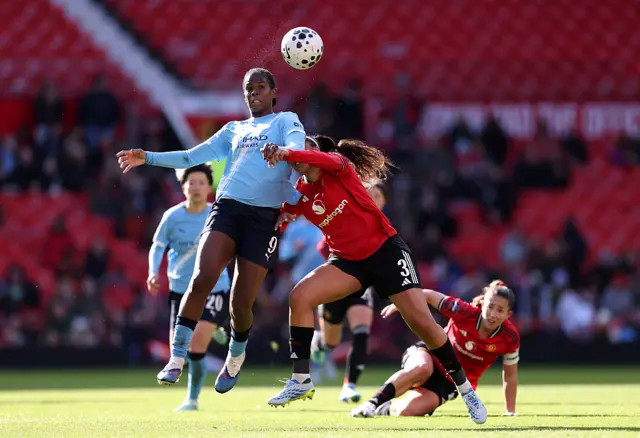 Khadija Shaw contends for the aerial ball with Gabby George