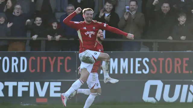 Matt Butcher celebrates his winning goal for Salford against MK Dons