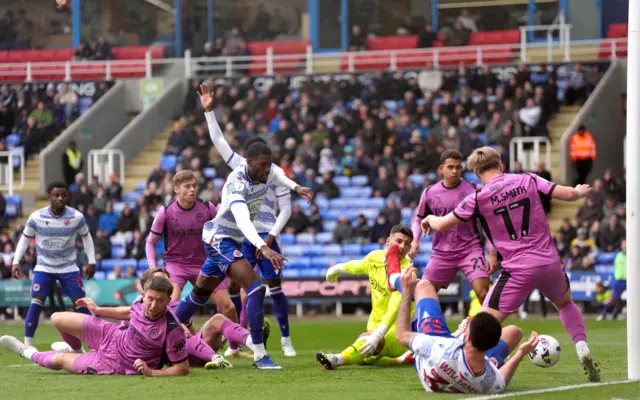 Reading's Kelvin Ehibhatiomhan scores their third goal against Wigan