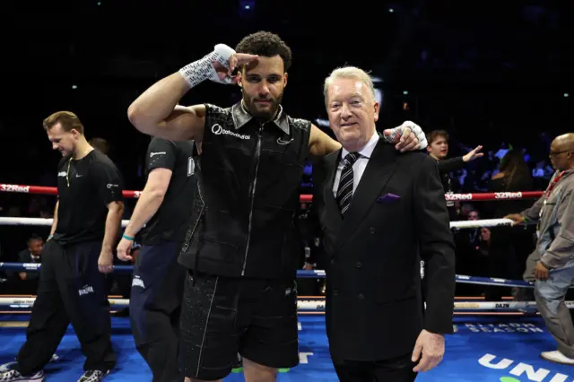 Moses Itauma salutes and puts his arm around the shoulder of Frank Warren