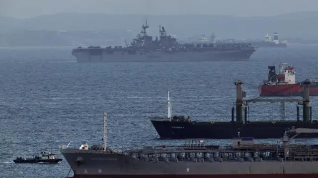 The USS Tripoli amphibious assault ship enters the Singapore Strait, amid the US-Israeli conflict with Iran, as seen from Singapore, 17 March 2026.