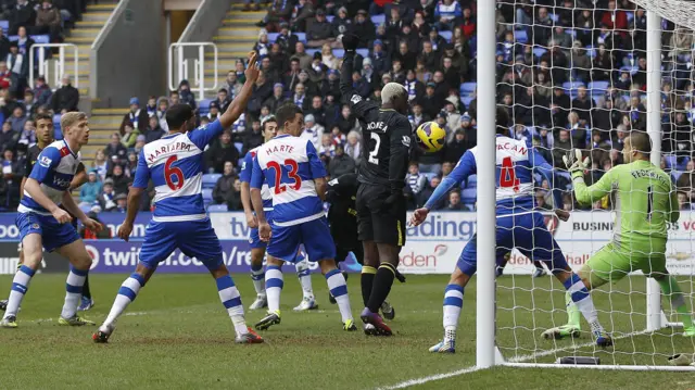 Arouna Kone scores for Wigan in a crowded penalty area in a game at Reading in the Premier League in February 2013