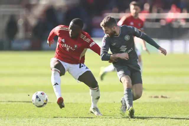 Daniel Udoh of Salford City and Daniel Crowley of Milton Keynes Dons